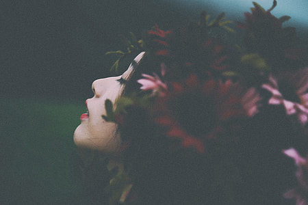selective focus photo of woman wearing red flower headdress thumbnail