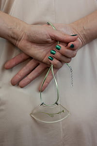 Person Holding Green Necklace thumbnail