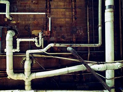 white pipes near brown wall thumbnail