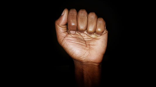 human fist with black background thumbnail