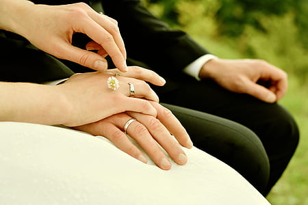 bride and groom sitting on chair holding hands thumbnail