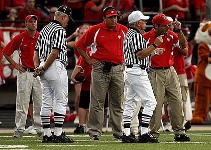 men standing on green football field thumbnail