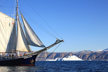 white and black sailboat near iceberg during daytime thumbnail