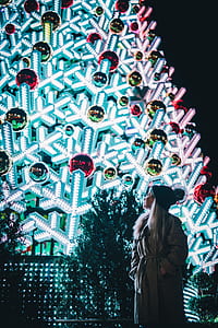 woman standing near lighted snowflake decor thumbnail
