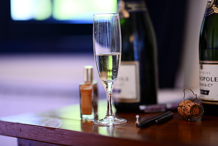 clear champagne glass filled with champagne on table thumbnail