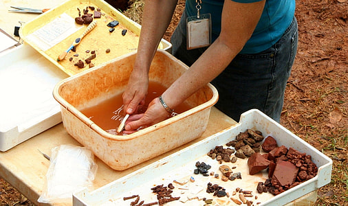 person brushing fossil stones thumbnail