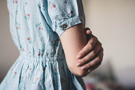 person wearing teal floral dress thumbnail