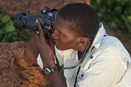 man holding black DSLR camera thumbnail
