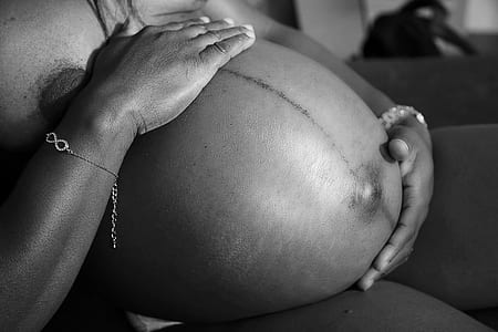grayscale photography of a pregnant woman thumbnail
