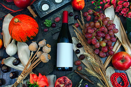 Photography of Wine Bottle on Table Between Fruits thumbnail