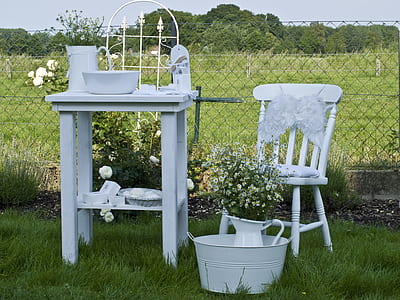 white table beside chair and pitcher with flowers thumbnail
