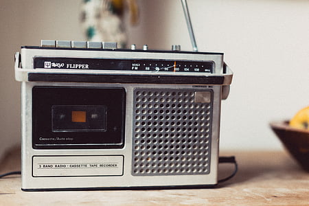 gray and black Flipper transistor radio on brown wooden surface thumbnail
