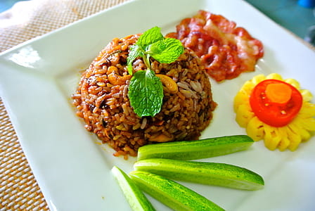 close-up photo of cooked rice with sliced cucumbers and tomato thumbnail
