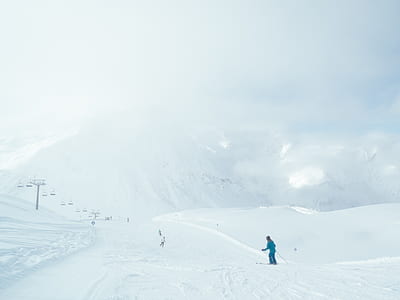 man using ski boards and stick on mountain during daytime thumbnail