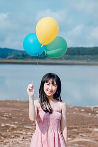 Photo of Woman Holding Balloons thumbnail