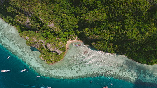 aerial photo of ships in front of an island thumbnail