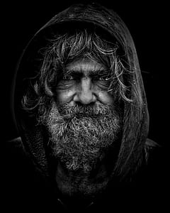 grayscale macro photograph of man in hoodie thumbnail