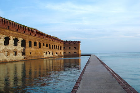 brown concrete structure near body of water thumbnail