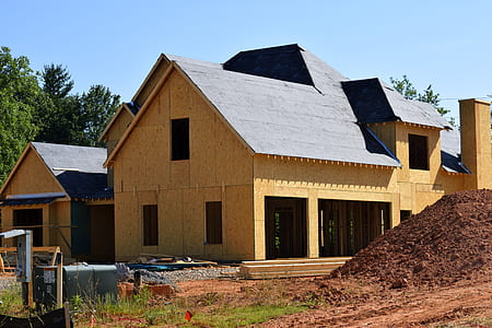 brown house beside soil under clear skies thumbnail