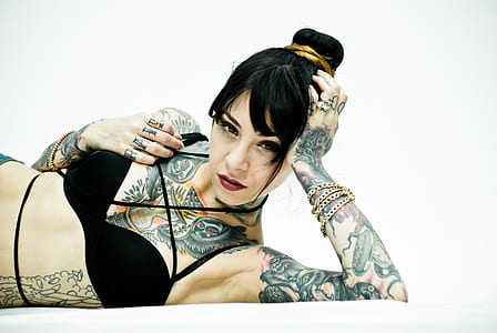 woman wearing black brassiere laying down resting head in left hand thumbnail