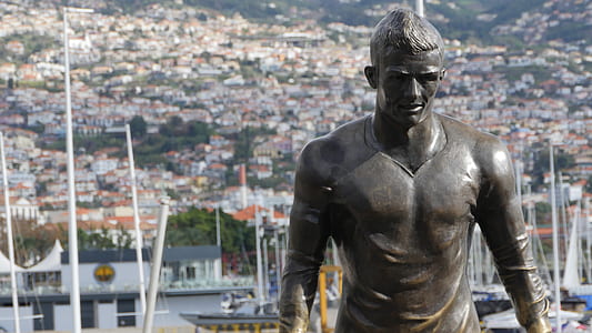 black and brown concrete statue of man thumbnail