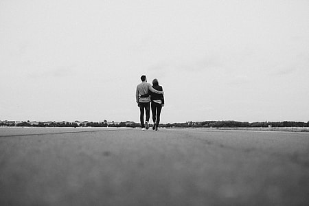 man and woman walking on pathway thumbnail