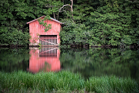 red house surrounded with trees thumbnail