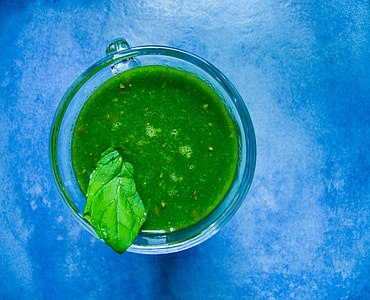 clear glass teacup filled with green liquid thumbnail
