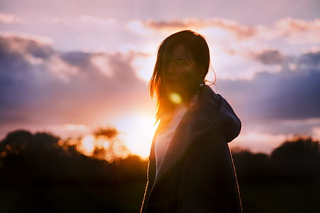 silhouette photography of woman wearing coat thumbnail