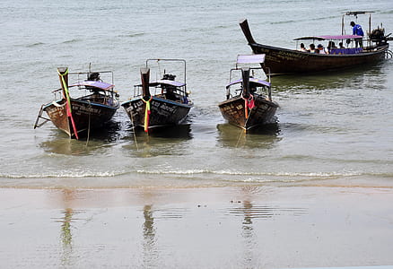 three black boats near seashore thumbnail