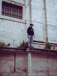 Man in Black Hooded Jacket Standing on Edge thumbnail