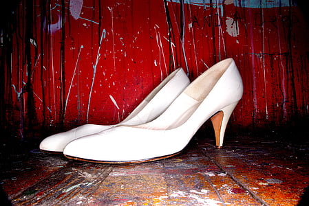 pair of women's white leather closed-toe pump on brown wooden table thumbnail