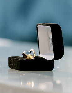 gold-colored ring on black box thumbnail