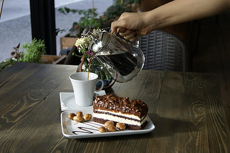 person pouring coffee on white mug thumbnail