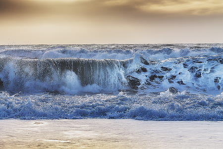 ocean waves taken under white clouds during daytime thumbnail