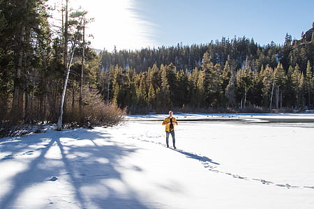 man standing on snow field during daytime thumbnail