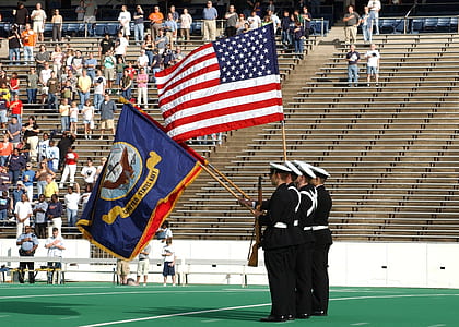 photo of four officer holding rifles and flags on field thumbnail