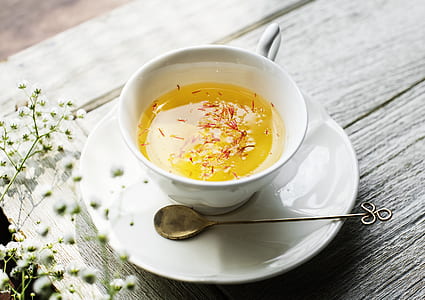 cup of tea on white saucer with spoon thumbnail