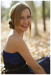 smiling woman wearing blue strapless shirt thumbnail