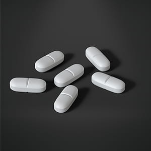 six oval white medication tablets thumbnail