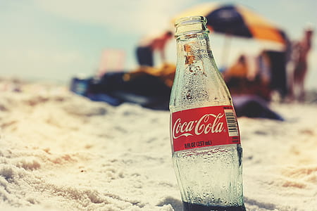 Coca-Cola glass bottle on seashore thumbnail