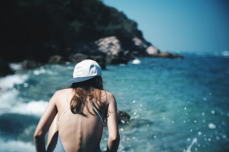 woman wearing white fitted cap near sea at daytime thumbnail