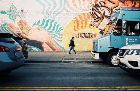 man walking across road thumbnail
