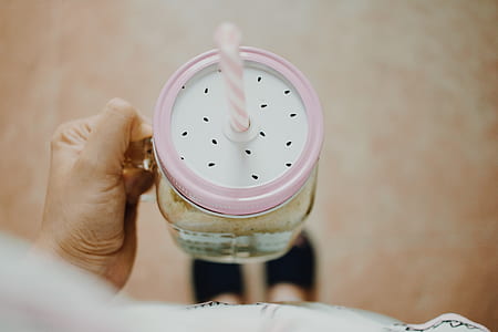 person holding clear glass mason jar thumbnail