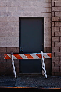 orange and white wooden road fence near gray door thumbnail