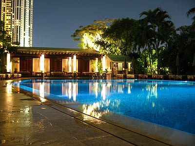 unoccupied swimming pool during night time thumbnail