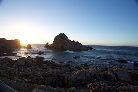 gray islet surrounded with body of water thumbnail