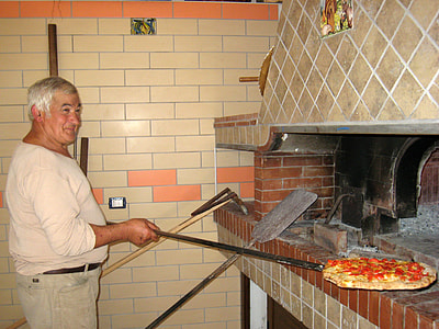 Man putting Pizza in the oven thumbnail