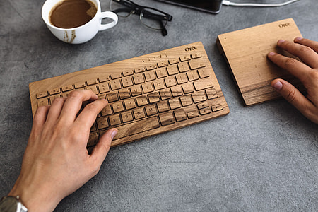 Young man typing on the wooden keyboard thumbnail