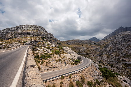 road under cloudy sky thumbnail